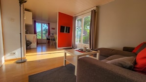 A modern living room with a sofa, a coffee table, and a dining area in the background. - On your terrace at the foot of an oak tree, feel the Alsace's vibes ! (Barr)