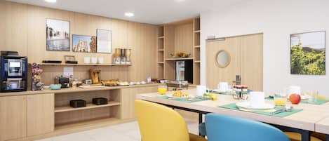 A modern kitchen with wooden cabinets, a coffee machine, and breakfast items on the counter.