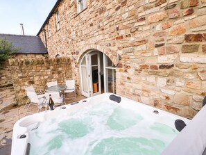 A stone building with a hot tub in the foreground. - Brancepeth (Bishop Auckland)