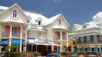 Un hotel con varias construcciones, un restaurante y varios coches estacionados.