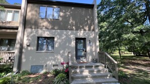 A two-story house with a front porch, a mailbox, and a mailbox number 795D.