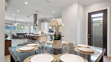 A modern kitchen with a dining area set for six.