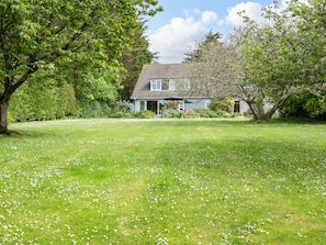 A house with a lawn and trees in the foreground. - Tregillan (Wadebridge)