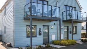 A two-story building with a balcony and a small porch area. - Seaquel (Bideford)