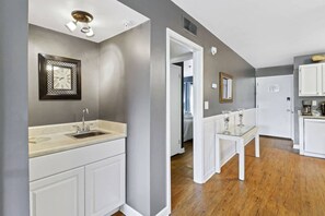 A modern kitchen with white cabinetry, a built-in sink, and a countertop. - Port Royal Sound 2BR Villa Balcony, Pools & Beach (Hilton Head Island)