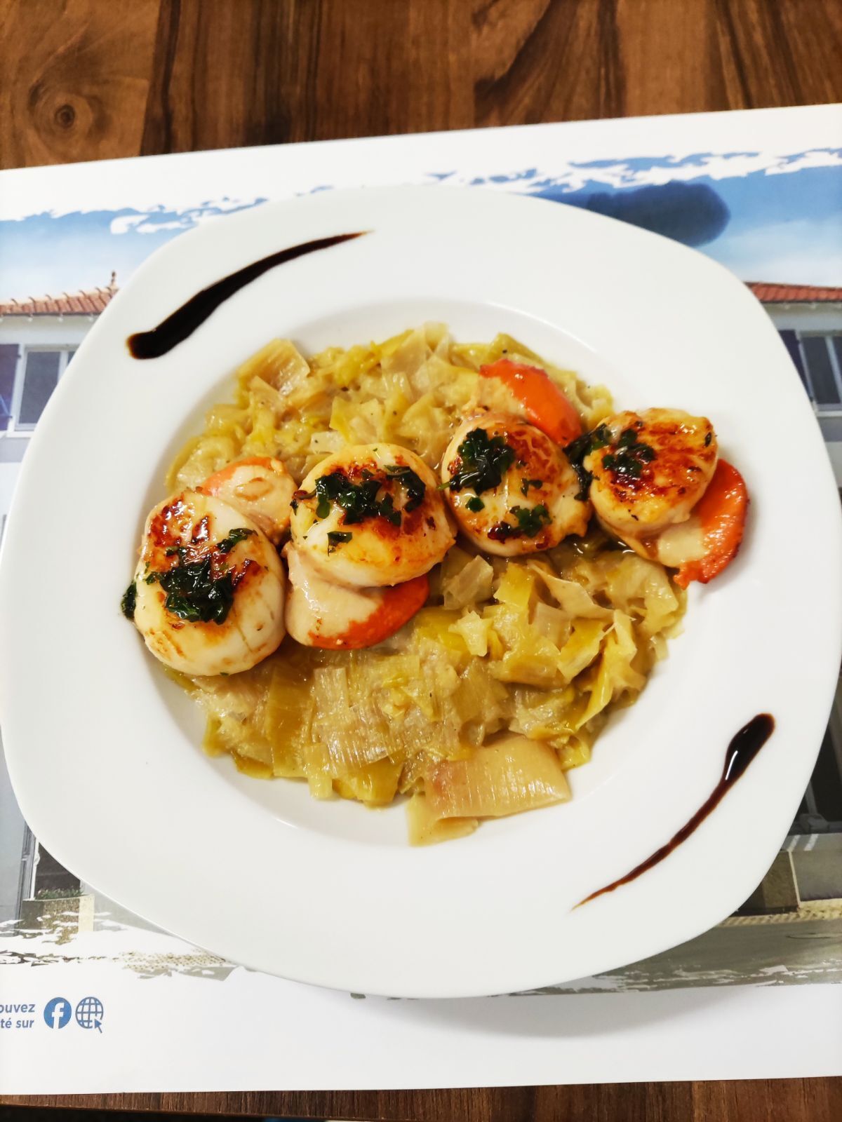 A plate of food with scallops and cabbage.