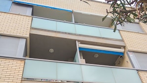 Un edificio de varios pisos con fachada de ladrillo y un balcón.