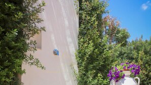 A large metal water tank, a white wall, and a potted plant with purple flowers. - TD Villa Marinesca Typical Villa With Pool (Polignano a Mare)