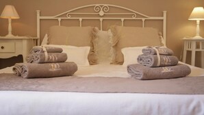 A neatly made bed with two pillows and two folded towels on either side. - TD Villa Marinesca Typical Villa With Pool (Polignano a Mare)