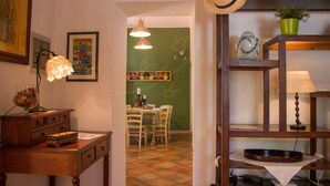 A cozy room with a wooden desk, a lamp, and a dining area with chairs and a table. - TD Villa Marinesca Typical Villa With Pool (Polignano a Mare)