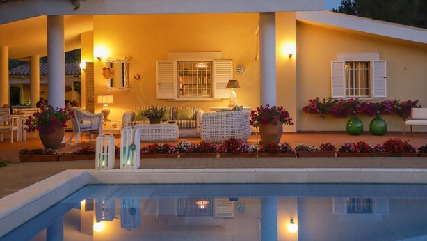 A poolside area with outdoor seating, a pool, and a building with a tiled roof. - TD Villa Marinesca Typical Villa With Pool (Polignano a Mare)