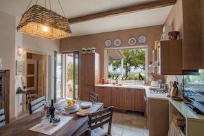 Enjoy meals in this open-plan kitchen and dining area with a view of the outdoors.