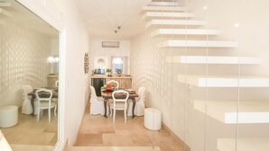 A modern interior with a staircase, a dining area, and a kitchen. - TD Dimora Arcadia With Breathtaking Sea View (Monopoli)
