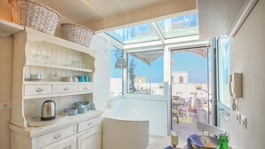 A compact kitchen with white cabinetry, a sink, and a window overlooking a balcony. - TD Dimora Arcadia With Breathtaking Sea View (Monopoli)