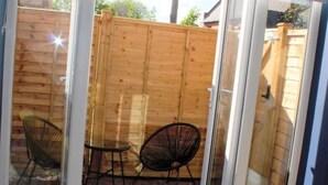 A room with a sliding glass door leading to an outdoor patio area. - Junior suite within walking distance of York city centre (York)