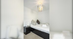 A modern bedroom with a bed, bedside tables, and a unique spherical light fixture. - Sleek 2BDR City Stay in the Heart of Edinburgh (Edinburgh)