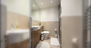A modern bathroom with a sink, toilet, and shower area.