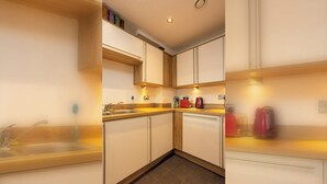 A modern kitchen with a sink, countertop, and cabinets.