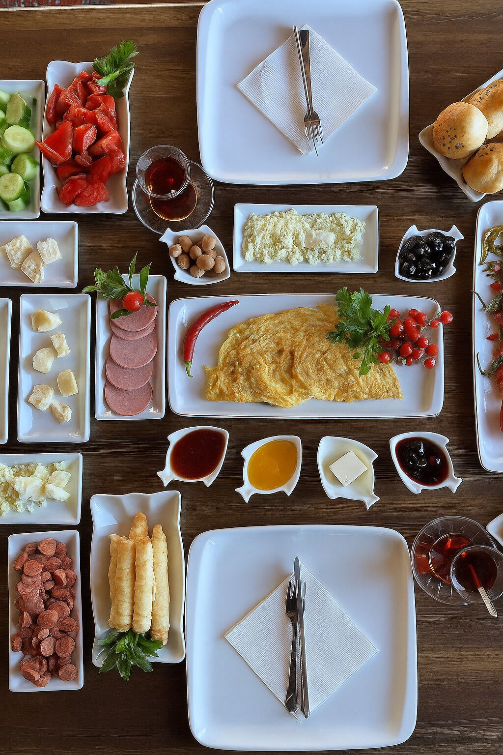 A variety of food items arranged on a wooden table.