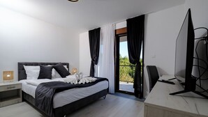 A modern bedroom with a bed, bedside table, and a balcony with curtains. - Apartment, 4BDR, shared pool (Sarajevo)