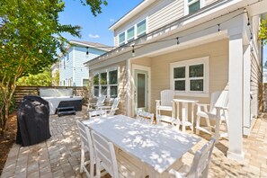 A patio with a barbecue grill, outdoor seating, and string lights. - ☀️ GOLF CART, HEATED POOL, Private Hot Tub, Bikes, Ping-Pong, Walk to Rosemary (Inlet Beach)
