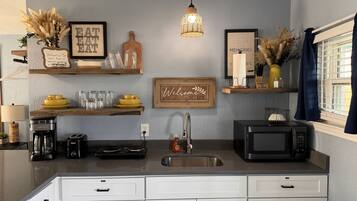 Fridge, microwave, coffee/tea maker, cookware/dishes/utensils