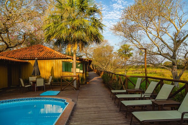 Outdoor pool, open 9:00 AM to 9:00 PM, pool umbrellas, pool loungers