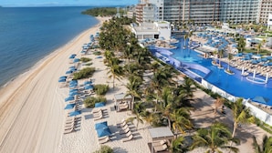A resort with a beach, a pool, and a large building with multiple balconies. - Royalton Splash Riviera Cancun, An Autograph Collection All-Inclusive Resort (Puerto Morelos)