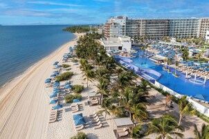 On the beach, white sand, sun loungers, beach umbrellas