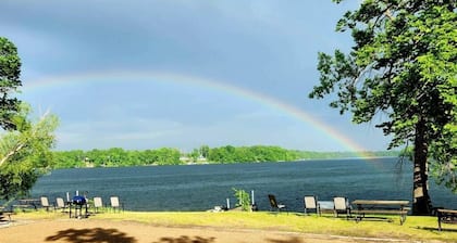Modern lakeside cabin with panoramic views and deck.