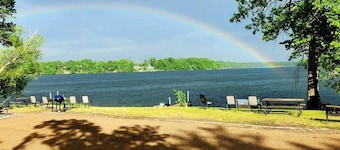 Modern lakeside cabin with panoramic views and deck.
