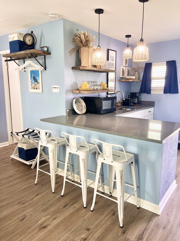 Fridge, microwave, coffee/tea maker, cookware/dishes/utensils