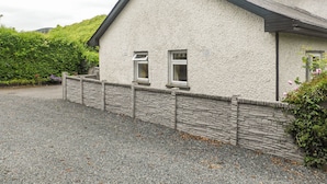 A two-story house with a stone facade and a sloped roof. - Borahard Lodge (Naas)
