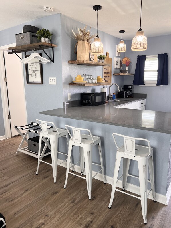 Fridge, microwave, coffee/tea maker, cookware/dishes/utensils