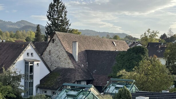 A hotel with a modern design, featuring a glass conservatory and a stone facade. - Bikehotel Freiburg (Merzhausen)