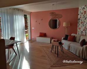 Relax in this inviting living space with a sofa, dining area, and natural views.