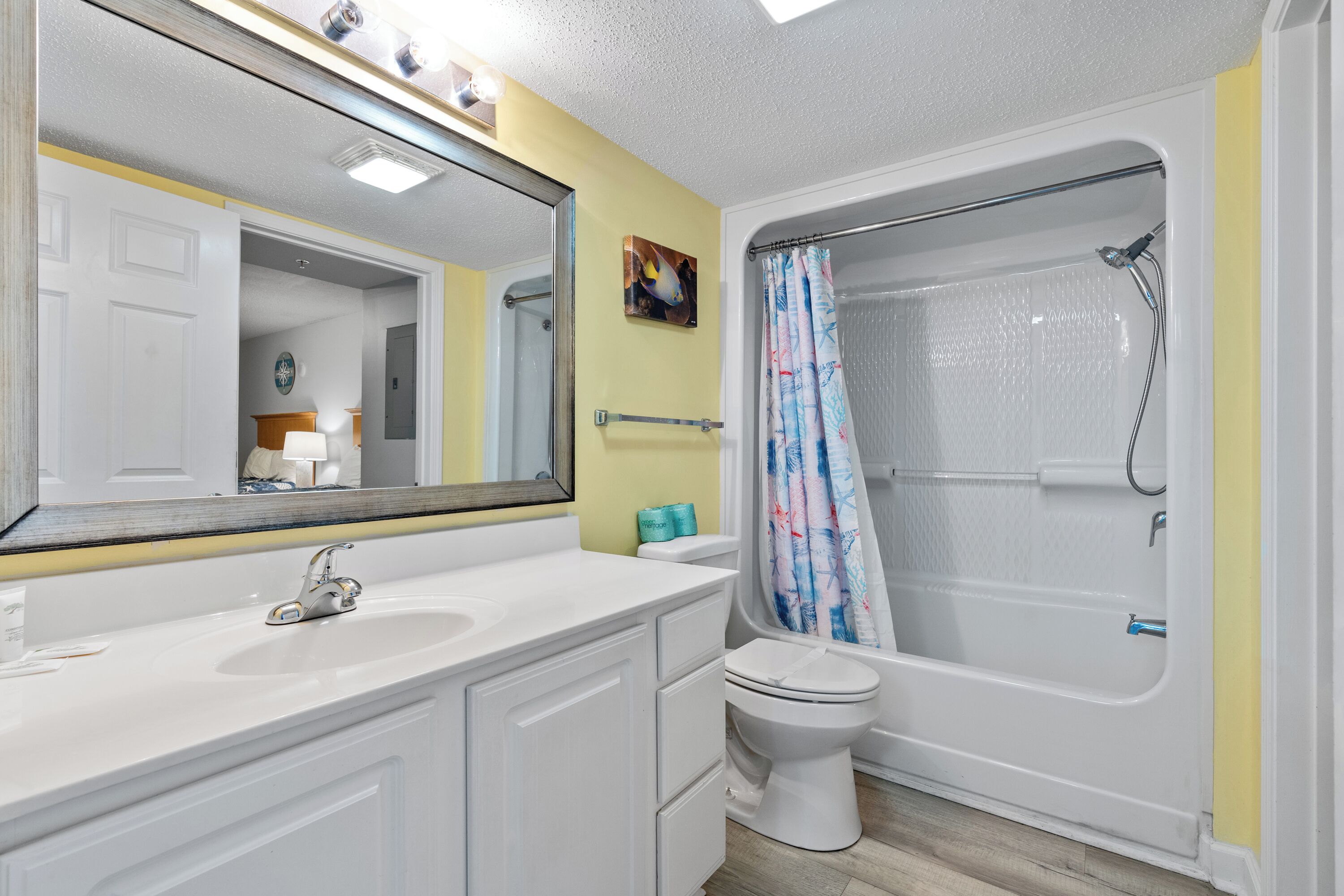 A bathroom with a white sink, toilet, and bathtub.