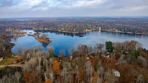 A lake surrounded by trees and houses.