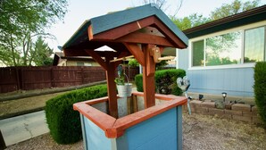 A blue and red outdoor water fountain with a wooden structure and a metal basin. - 3 blks to Historic downtown Courthouse & Whiskey Row. King bed. Dog Friendly (Prescott)