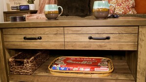 A wooden dresser with two mugs on top, a Scrabble game tray, and a wicker basket underneath. - 3 blks to Historic downtown Courthouse & Whiskey Row. King bed. Dog Friendly (Prescott)
