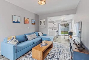 Relax in this inviting living space with a comfortable sofa, coffee table, and large window.