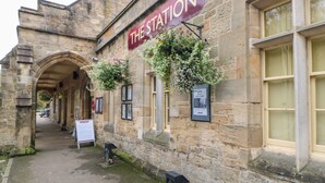 A stone building with a sign reading "THE STATION". - Woodland View (Richmond)
