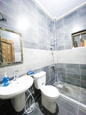 Bathtub, towels, soap, toilet paper