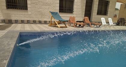 Cheerful two bedrooms villa with warm pool, playground,& specious sitting room.