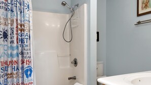 A bathroom with a shower, toilet, and sink. - Dunes Club 1D (Port St. Joe)