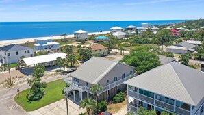 A coastal residential area with houses, a beach, and a clear blue sky. - Sweet Home Apalachee (Port St. Joe)