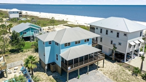 A coastal property with multiple buildings, a beach view, and a swimming pool. - Beach Please (Port St. Joe)