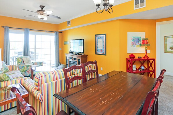 Cozy living area with a large dining table and comfortable seating, perfect for relaxing and enjoying a meal.