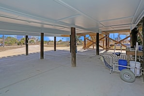 Exposed wooden beams and metal supports frame this unfinished space.
