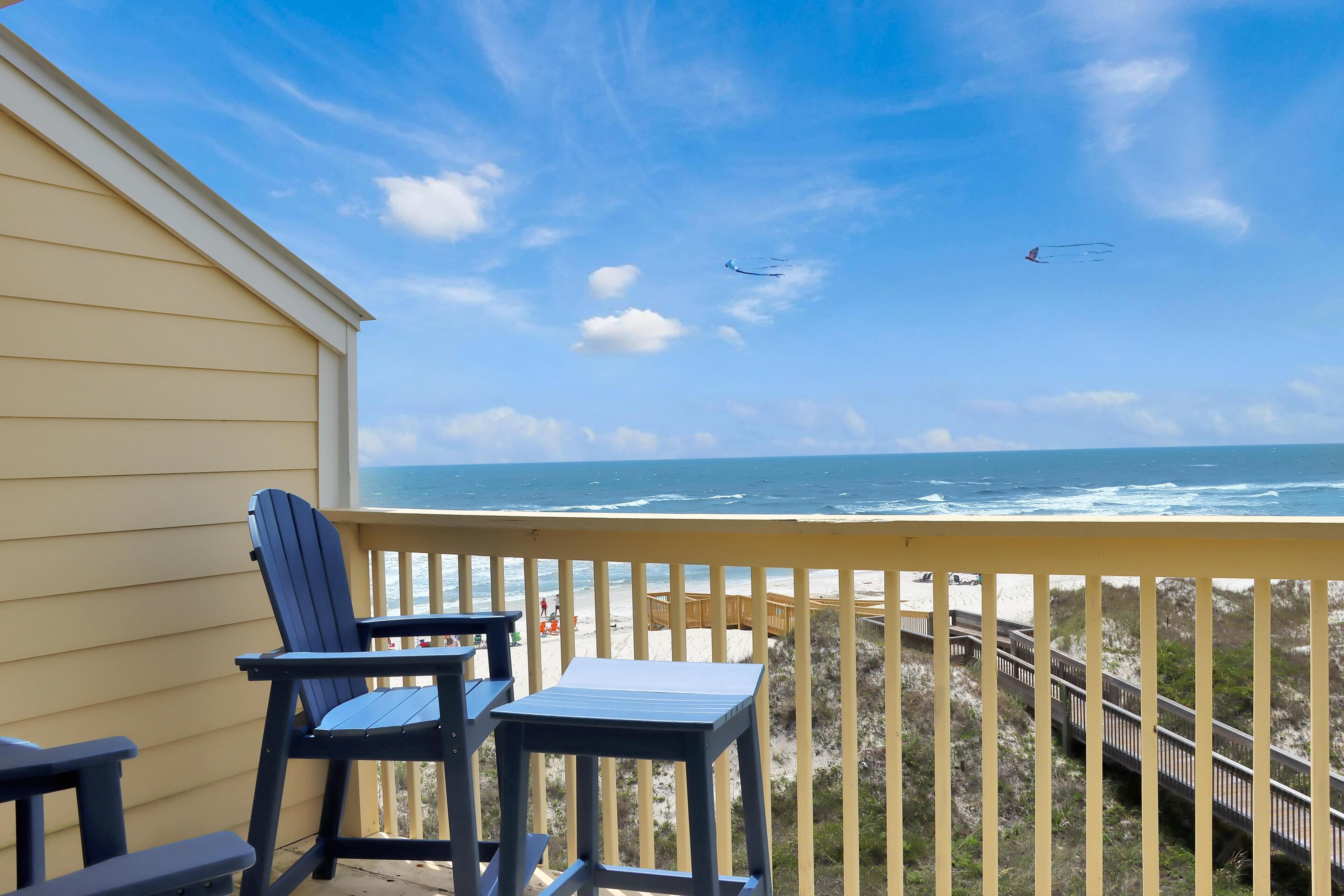 Parveke, josta on näkymä merelle, puinen terassi ja tuoli.
